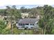 Aerial view of a two-story home with a screened porch, blue shutters, and a large yard at 809 Northside Dr, Mount Dora, FL 32757