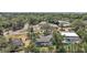 Aerial view of beautiful home with screened-in pool surrounded by mature trees in an established neighborhood at 809 Northside Dr, Mount Dora, FL 32757