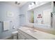 Bright bathroom features an extended vanity countertop and a large mirror at 809 Northside Dr, Mount Dora, FL 32757