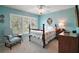 Light filled bedroom with shuttered windows, ceiling fan and vintage furniture at 809 Northside Dr, Mount Dora, FL 32757