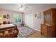 Cozy bedroom with a window, closet, and an antique dresser at 809 Northside Dr, Mount Dora, FL 32757