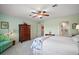 Cozy bedroom with large dresser, queen bed, and an ensuite bathroom at 809 Northside Dr, Mount Dora, FL 32757