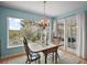 Dining area features large windows with natural light and access to the outdoor patio through French doors at 809 Northside Dr, Mount Dora, FL 32757
