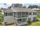 Back of the house featuring a screened porch and under-deck patio at 809 Northside Dr, Mount Dora, FL 32757