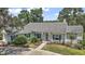 Charming single-story home with blue shutters, manicured lawn, and inviting walkway at 809 Northside Dr, Mount Dora, FL 32757