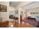 Open hallway with hardwood floors connecting multiple rooms of the home at 809 Northside Dr, Mount Dora, FL 32757