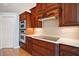 Close up of kitchen boasting stainless steel appliances, sleek countertops, and rich wood cabinetry at 809 Northside Dr, Mount Dora, FL 32757