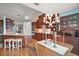 Open layout with kitchen island, wood cabinets, and dining area with decorative chandelier at 809 Northside Dr, Mount Dora, FL 32757