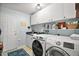 Functional laundry room with washer, dryer, sink and ample storage space at 809 Northside Dr, Mount Dora, FL 32757