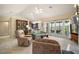 Spacious living room with high ceilings, glass doors to a balcony, and a view of lush greenery at 809 Northside Dr, Mount Dora, FL 32757
