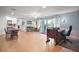 Spacious living room area with sliding glass doors and a decorative writing desk at 809 Northside Dr, Mount Dora, FL 32757