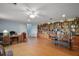Bright living room area featuring laminate flooring and a wall of built-in shelving at 809 Northside Dr, Mount Dora, FL 32757