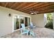Under-deck patio featuring brick pavers, ceiling fan, and sliding glass doors at 809 Northside Dr, Mount Dora, FL 32757