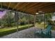 Under-deck patio features brick pavers, ceiling fan, and wooded backyard at 809 Northside Dr, Mount Dora, FL 32757