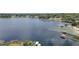 Scenic aerial view of a large lake featuring a dock and beautiful waterfront homes along the shoreline at 809 Northside Dr, Mount Dora, FL 32757