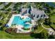 Community clubhouse with a large pool, ample parking, and lush landscaping and manicured lawns at 8664 Bridgeport Bay Cir, Mount Dora, FL 32757