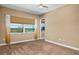 This bedroom features a ceiling fan and large window with peaceful lake views at 8664 Bridgeport Bay Cir, Mount Dora, FL 32757