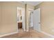 Neutral bedroom with a view to the en-suite bathroom, and an open doorway into a closet at 8664 Bridgeport Bay Cir, Mount Dora, FL 32757