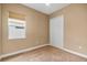 Cozy bedroom with neutral walls, plush carpeting, window with blinds, and closet with bi-fold doors at 8664 Bridgeport Bay Cir, Mount Dora, FL 32757