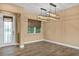 Spacious dining room with modern lighting and a view of the front yard at 8664 Bridgeport Bay Cir, Mount Dora, FL 32757