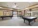Well-appointed game room featuring multiple pool tables and classic decor for leisure and entertainment at 8664 Bridgeport Bay Cir, Mount Dora, FL 32757