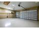 Spacious two car garage featuring epoxy flooring, automatic doors, and a window for natural light at 8664 Bridgeport Bay Cir, Mount Dora, FL 32757
