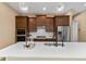 The kitchen includes a large island with quartz countertops, pendant lighting, stainless steel appliances, and custom cabinets at 8664 Bridgeport Bay Cir, Mount Dora, FL 32757