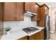 Modern kitchen with stainless steel appliances, gas cooktop, quartz countertops, custom wood cabinets, and subway tile backsplash at 8664 Bridgeport Bay Cir, Mount Dora, FL 32757