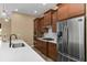 This kitchen boasts stainless steel appliances, quartz countertops, custom cabinets, gas cooktop, and pendant lighting at 8664 Bridgeport Bay Cir, Mount Dora, FL 32757