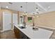 The kitchen showcases a large island, pendant lighting, stainless steel appliances, and open access to other rooms at 8664 Bridgeport Bay Cir, Mount Dora, FL 32757
