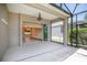 View from a spacious lanai looking into the interior of the home, with a view to the backyard at 8664 Bridgeport Bay Cir, Mount Dora, FL 32757