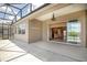 Spacious covered lanai area with view of the interior, water, and blue sky at 8664 Bridgeport Bay Cir, Mount Dora, FL 32757