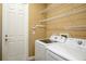 Well-organized laundry room with modern washer and dryer and shelving at 8664 Bridgeport Bay Cir, Mount Dora, FL 32757