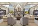 Cozy library with comfortable seating, extensive bookshelves, and natural light, creating a perfect reading space at 8664 Bridgeport Bay Cir, Mount Dora, FL 32757