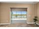 Bright living room with sliding glass doors offering stunning views of the lake at 8664 Bridgeport Bay Cir, Mount Dora, FL 32757
