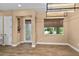 Dining room features natural light with tile floors, a decorative glass front door, and neutral colored walls at 8664 Bridgeport Bay Cir, Mount Dora, FL 32757