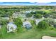A lovely home located in a golf community with a pond; aerial view shows beautiful green spaces and landscaping at 8709 Augusta Ct, Clermont, FL 34711