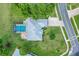 Aerial view of a single Gathering home with a screened-in pool, driveway, and lush landscaping at 8709 Augusta Ct, Clermont, FL 34711