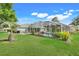 This is a view of the backyard with screened in pool area and landscaping at 8709 Augusta Ct, Clermont, FL 34711