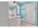 This bathroom features blue walls, a white vanity and a tiled floor at 8709 Augusta Ct, Clermont, FL 34711