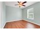 The bedroom features a ceiling fan, neutral paint, and hardwood floors at 8709 Augusta Ct, Clermont, FL 34711