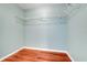 Empty closet with a wire rack for plenty of extra storage and wood flooring at 8709 Augusta Ct, Clermont, FL 34711