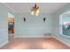 Light-filled dining room featuring tile flooring, modern lighting, and large window at 8709 Augusta Ct, Clermont, FL 34711