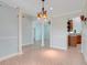 Open dining room with tile floors, decorative columns, and access to kitchen and living areas at 8709 Augusta Ct, Clermont, FL 34711