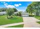 Charming single Gathering home with a well-manicured lawn, mature trees, and two-car garage at 8709 Augusta Ct, Clermont, FL 34711