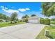 Single-Gathering home with a well-manicured lawn, mature trees, and two-car garage and long driveway at 8709 Augusta Ct, Clermont, FL 34711