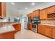Well-equipped kitchen featuring stainless steel appliances, tiled countertops, and ample cabinet space at 8709 Augusta Ct, Clermont, FL 34711