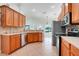 Modern kitchen with stainless steel appliances, wooden cabinets, and tile backsplash at 8709 Augusta Ct, Clermont, FL 34711