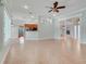 Spacious living room with tile flooring, an open floor plan, and decorative columns at 8709 Augusta Ct, Clermont, FL 34711