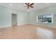 Open living room with tile floors and a large window looking out onto the pool at 8709 Augusta Ct, Clermont, FL 34711